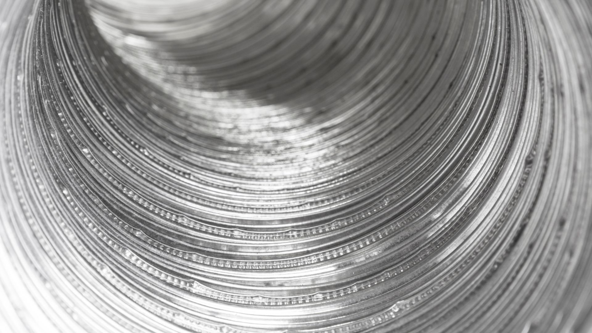 Black and white close-up of concentric circular metal texture